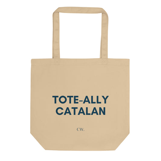Tote bag beige de cotó orgànic amb text blau fosc "Tote-ally Catalan", disseny minimalista i divertit de Catalan Words.